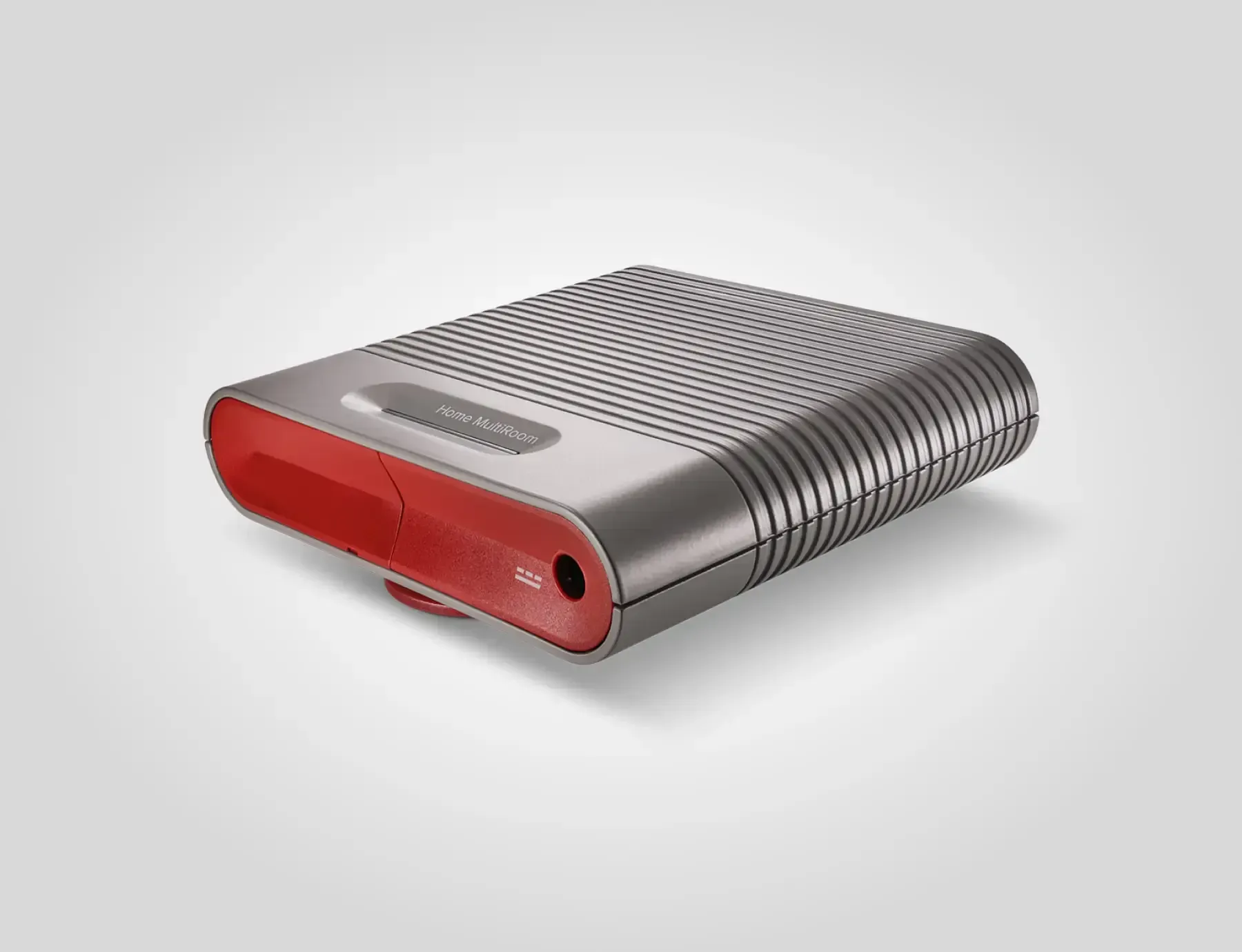 Silver and red audio device with ridged sides and rounded corners.