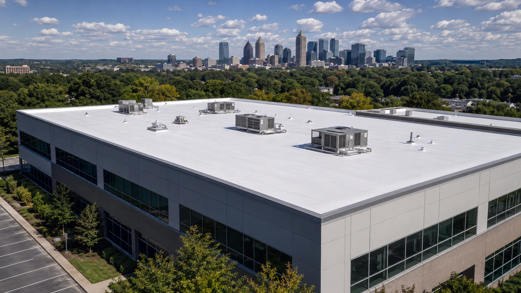 Two orange hard hats on a white rooftop with safety lines and trees in the background