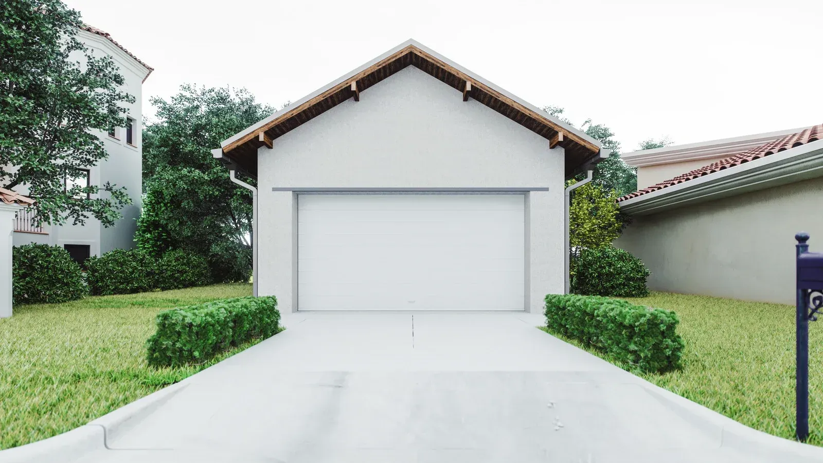 Small white house with a closed garage door and a driveway, bordered by trimmed hedges and green lawn.
