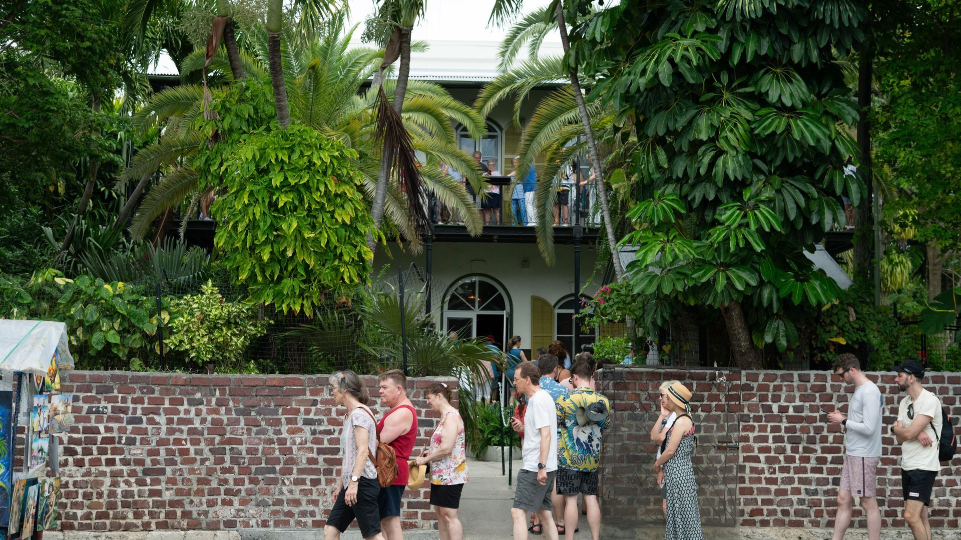 Visitors lining up at the Ernest Hemingway Home and Museum, a must-see historic attraction in Key West Florida