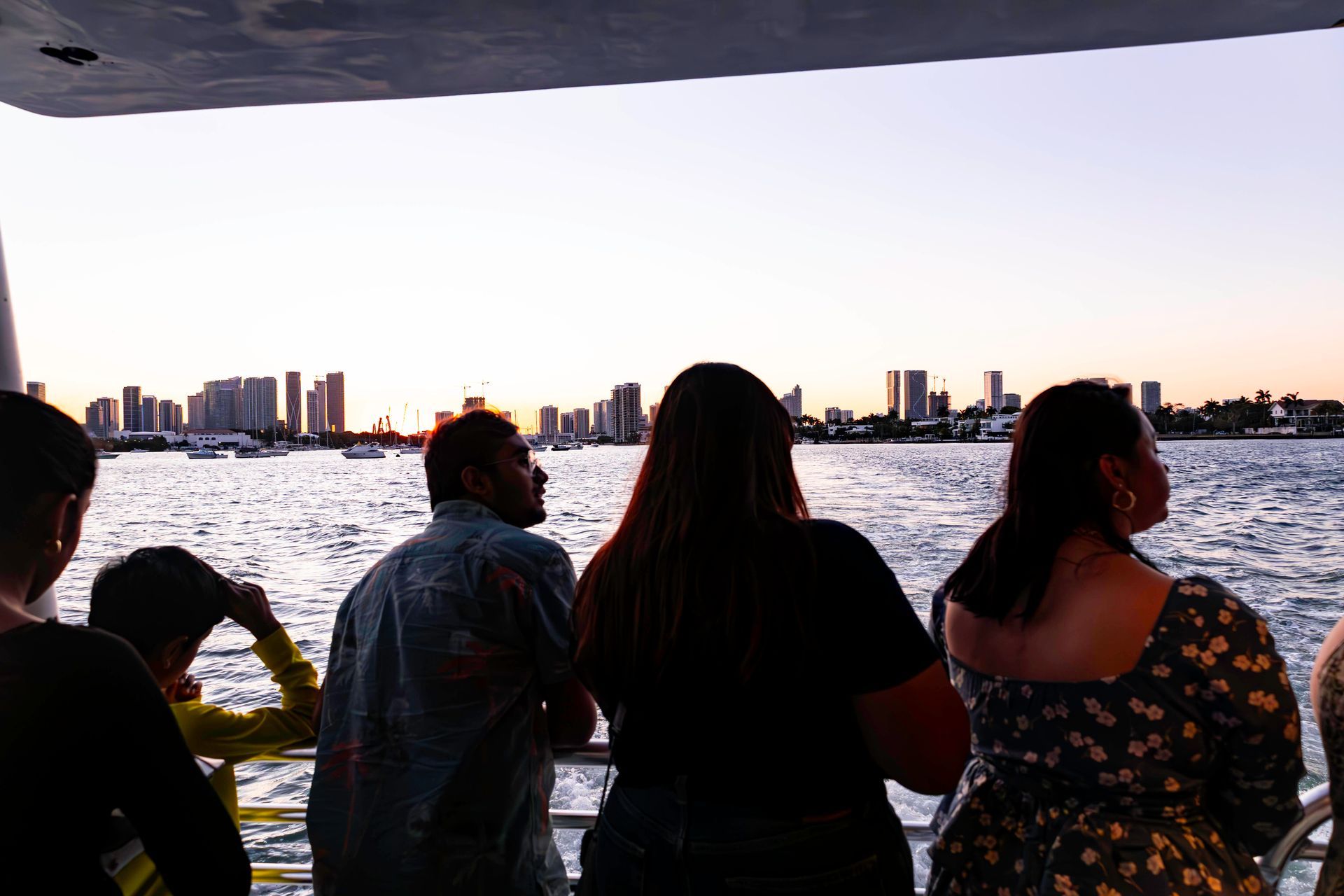 Cruise guests enjoying sunset views of Biscayne Bay and the Miami skyline during a Star Island Mansion tour