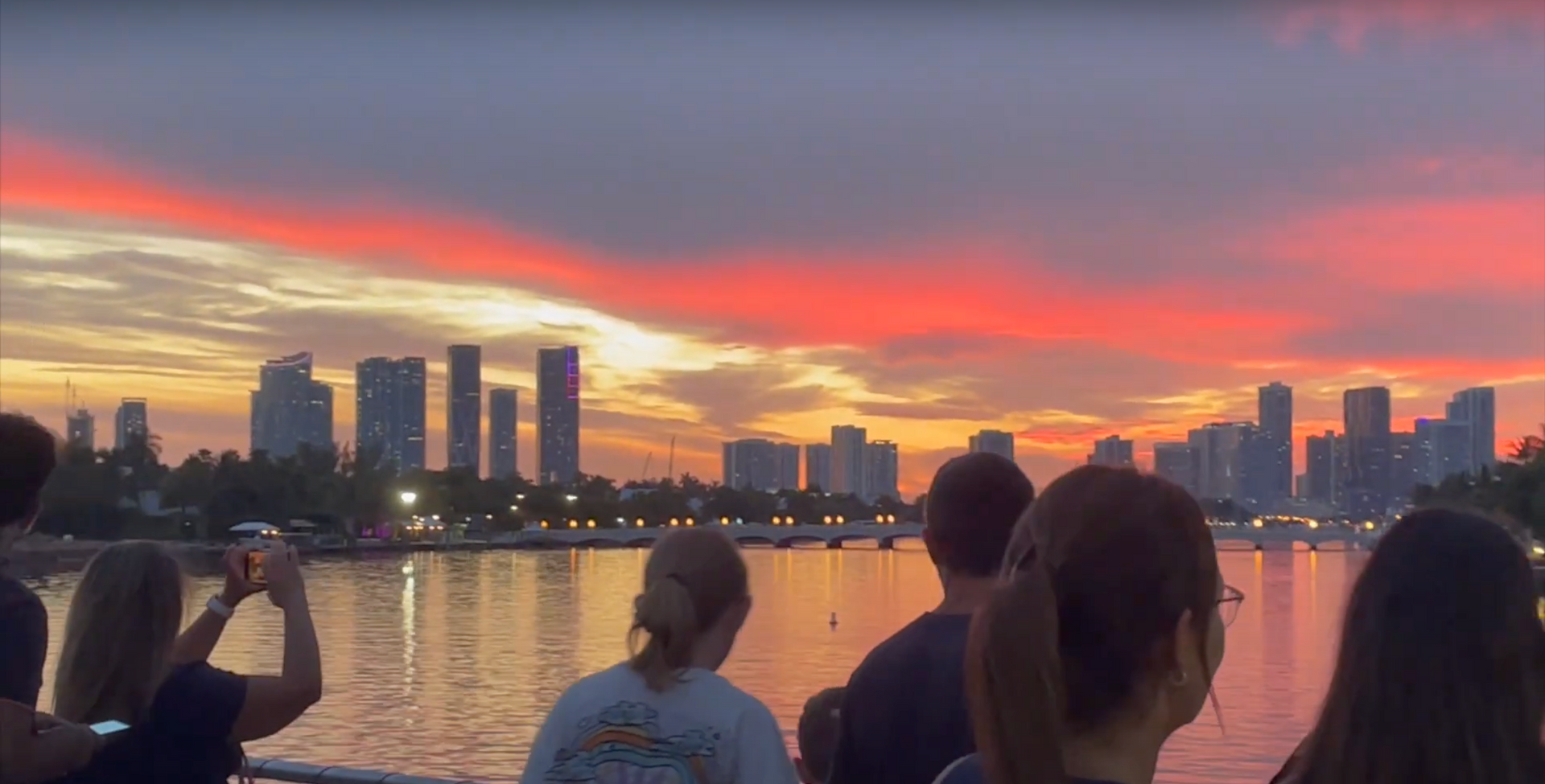 Sunset Cruise in Miami with passengers taking photos of the Miami Skyline at Sunset in Miami. 