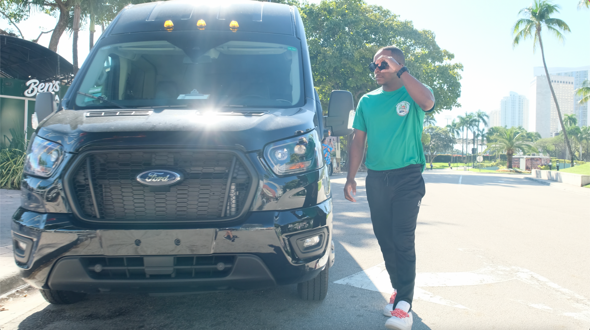 tour Guide of the Miami tour bus walking into Bayside to pick up passengers for the Miami tour experience