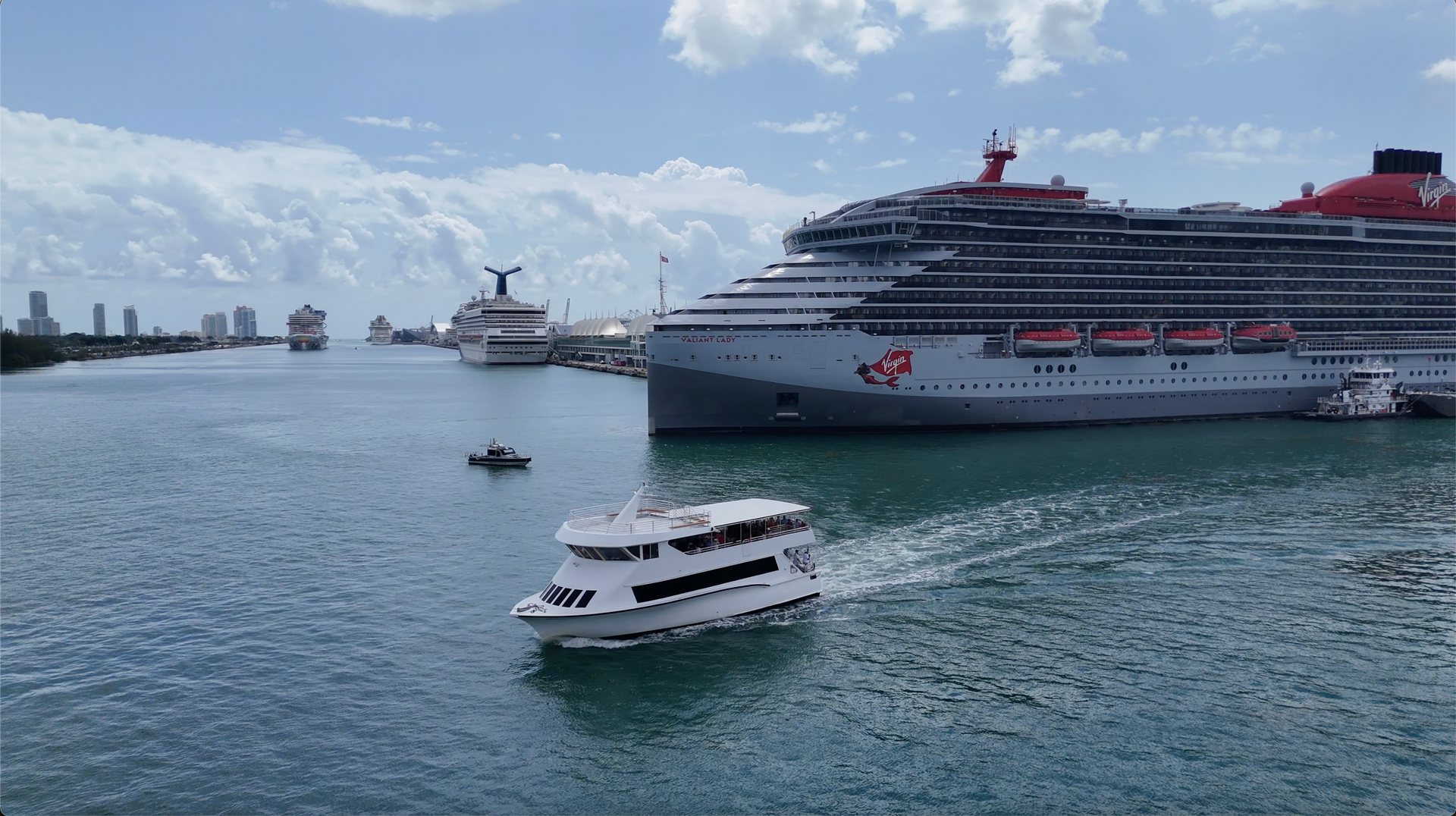 Miami Sightseeing cruise passing by the port of Miami next to a cruise ship