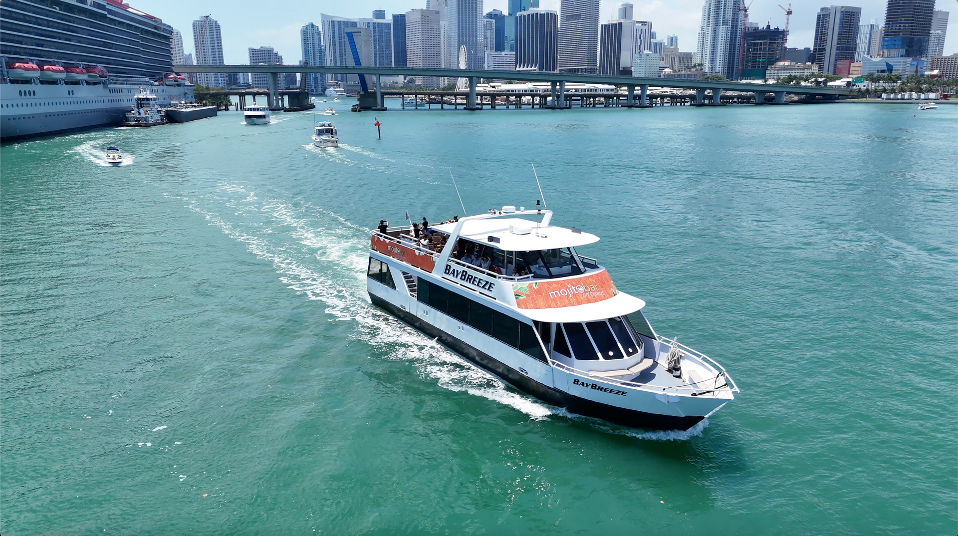 The Miami boat tour heading to the mansions in Star island, with the Miami skyline in the background.