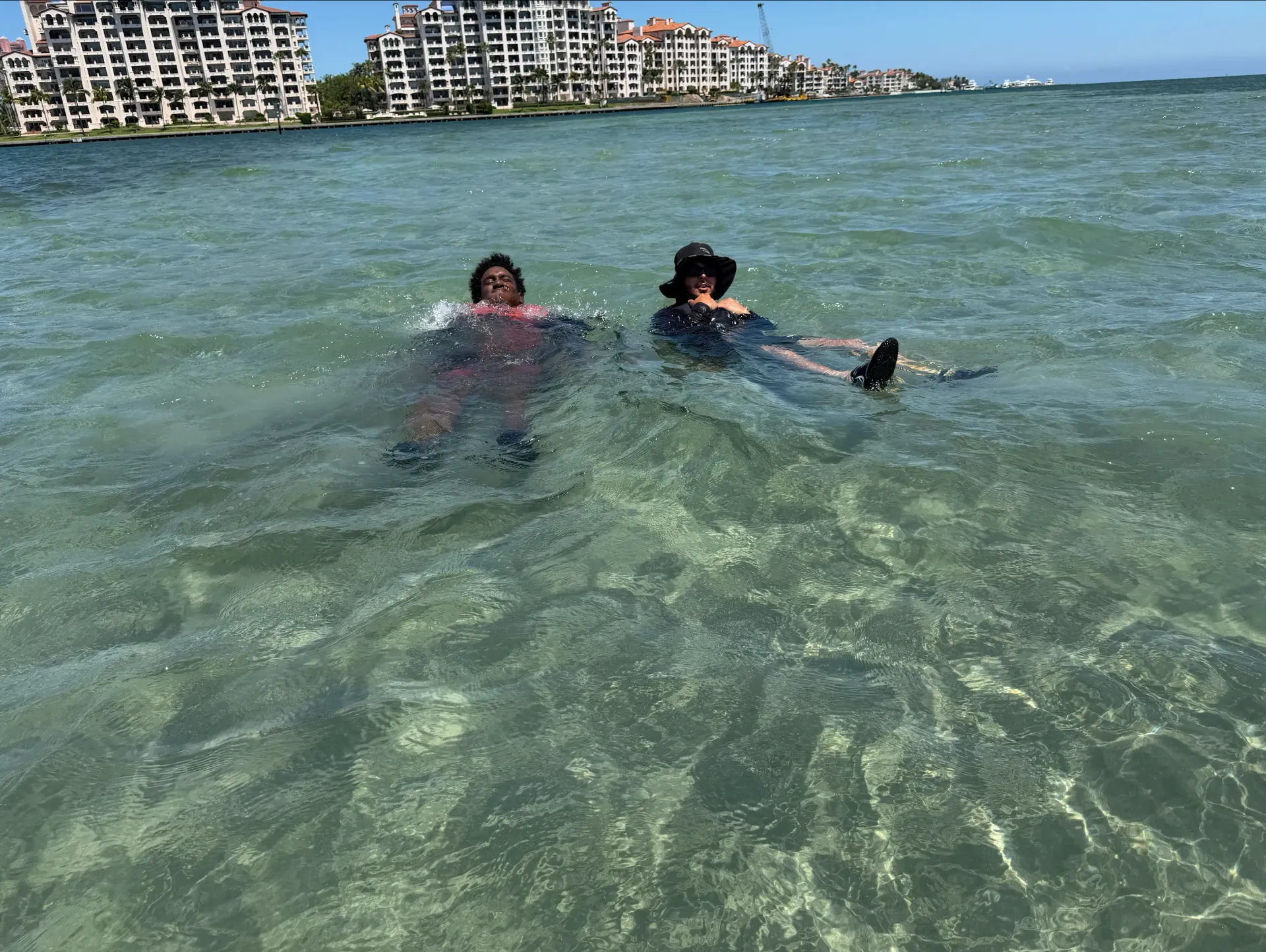 Guests relaxing in the water during a Fisher Island sandbar stop on a Miami Jet Ski Tour