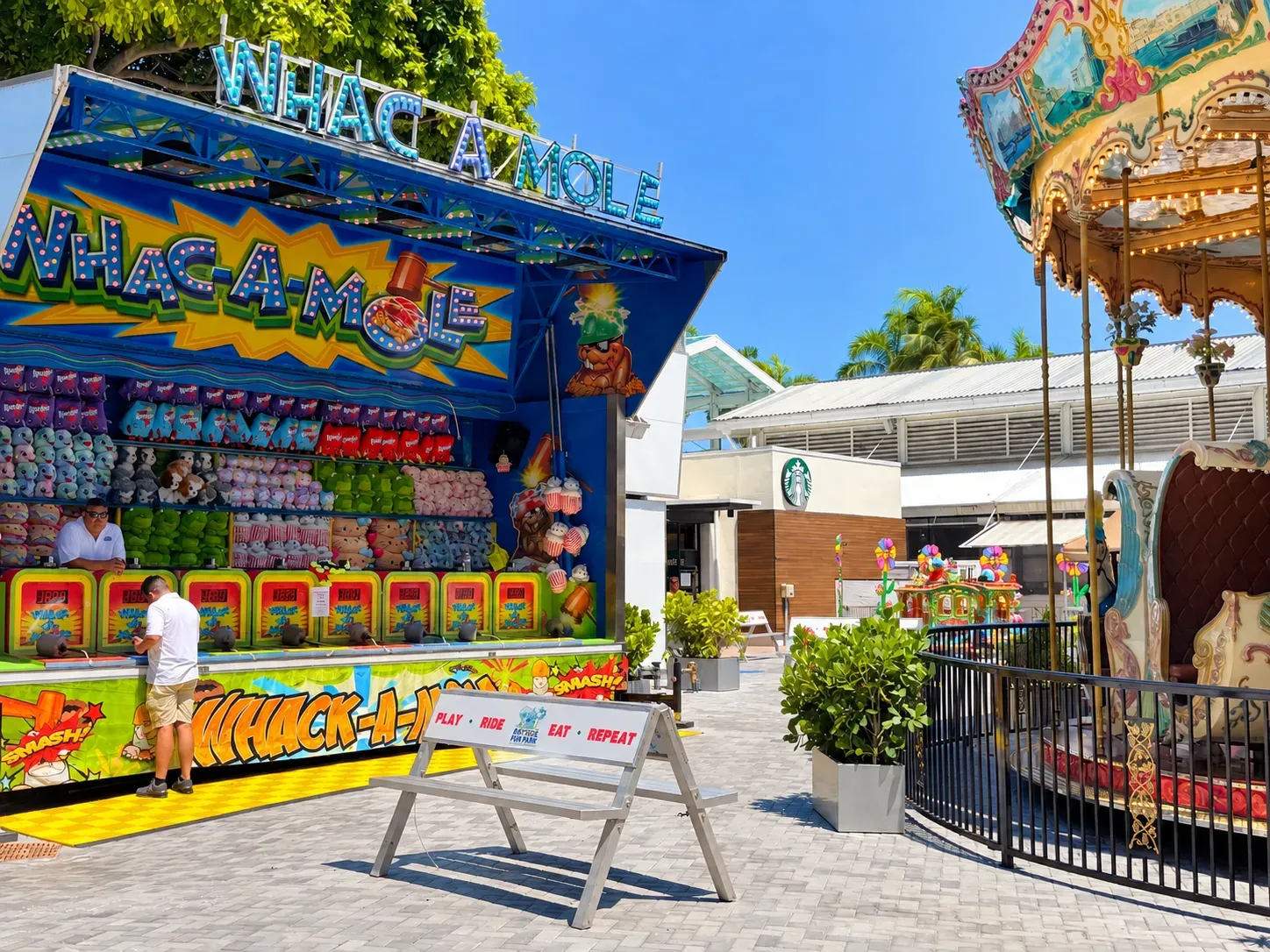 Whac-A-Mole game and carousel at Miami Bayside Fun Park.