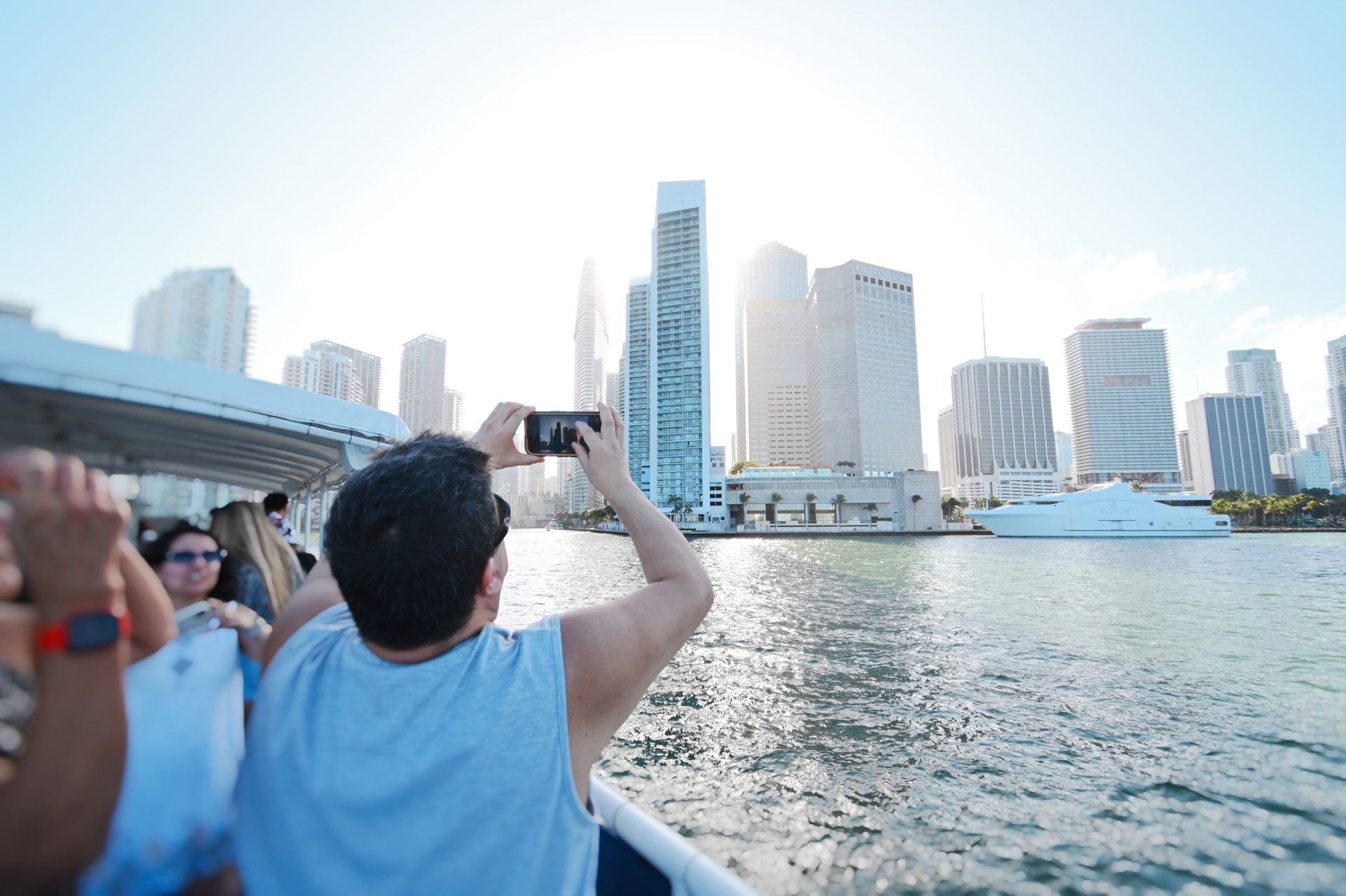 Guest on the Miami boat tour with the Miami Skyline taking photos