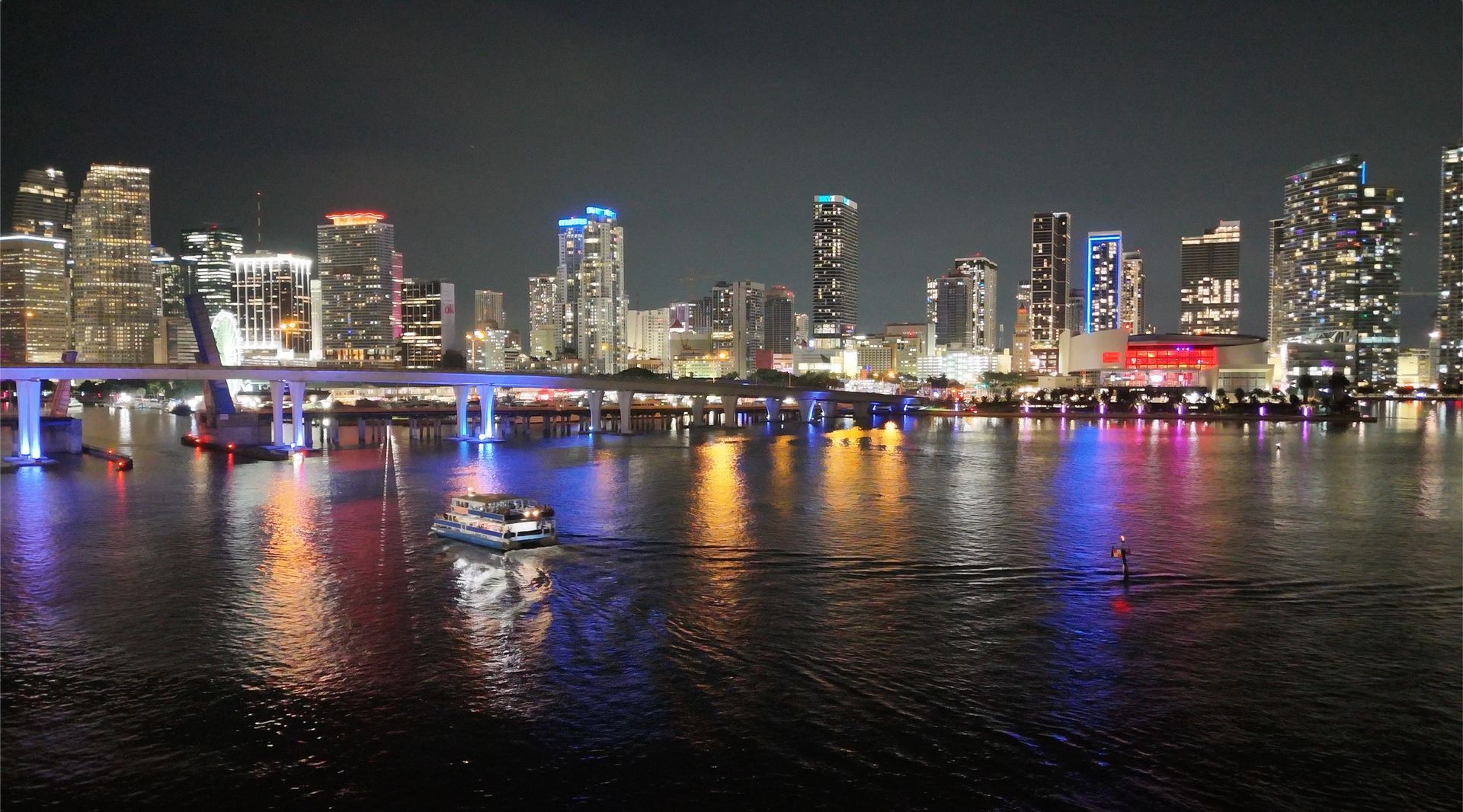 Miami skyline at night viewed from a sightseeing cruise on Biscayne Bay.