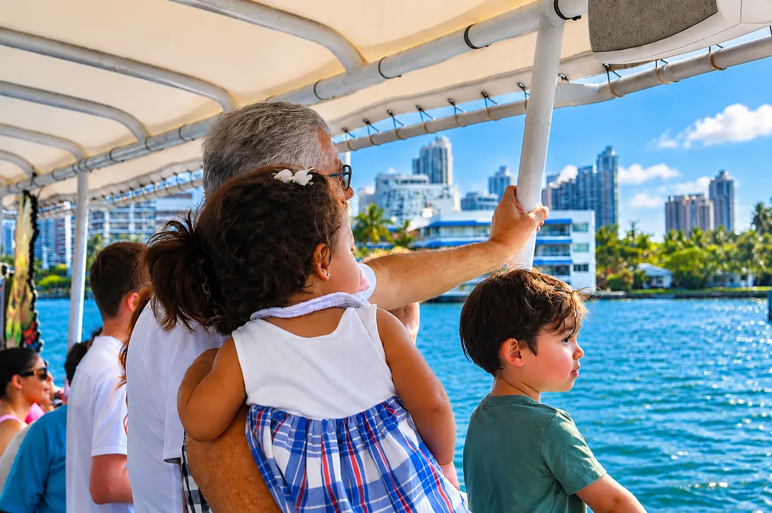 Family sightseeing aboard a Miami Skyline Cruise on Biscayne Bay