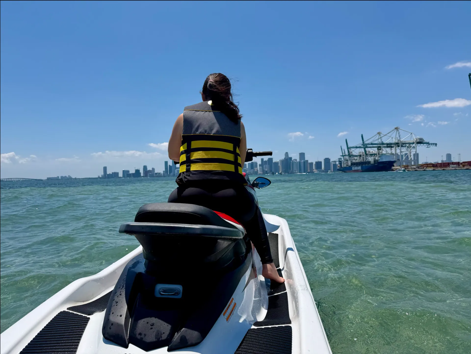 Guest enjoying a Tour Miami Jet Ski Rental experience with views of the Downtown Miami skyline across Biscayne Bay