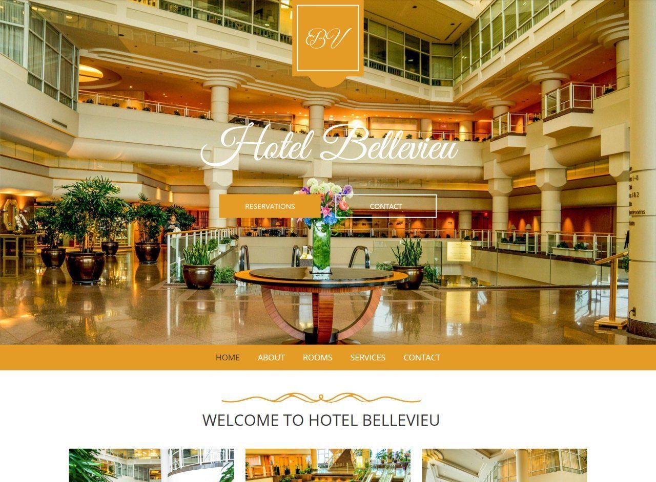 A website for a hotel with a table in the middle of the lobby.