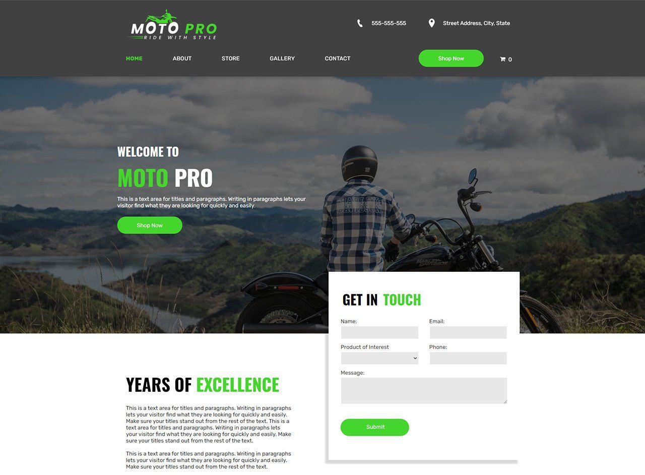 A man is sitting on a motorcycle on top of a mountain.