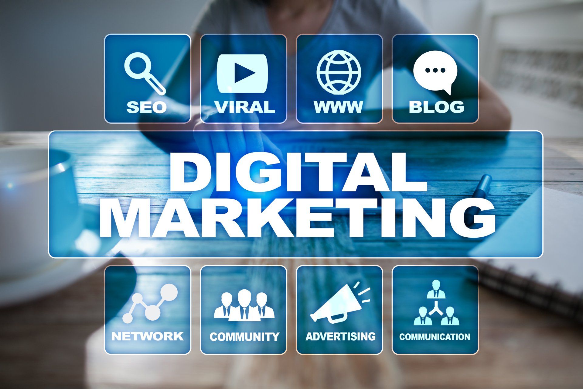 A person is using a laptop computer and pressing a button that says digital marketing.