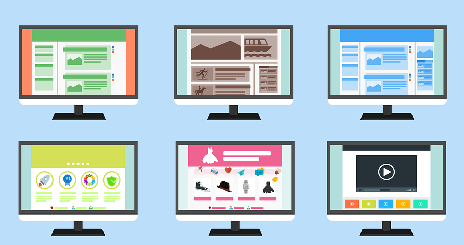 A set of computer monitors with different types of websites on them.