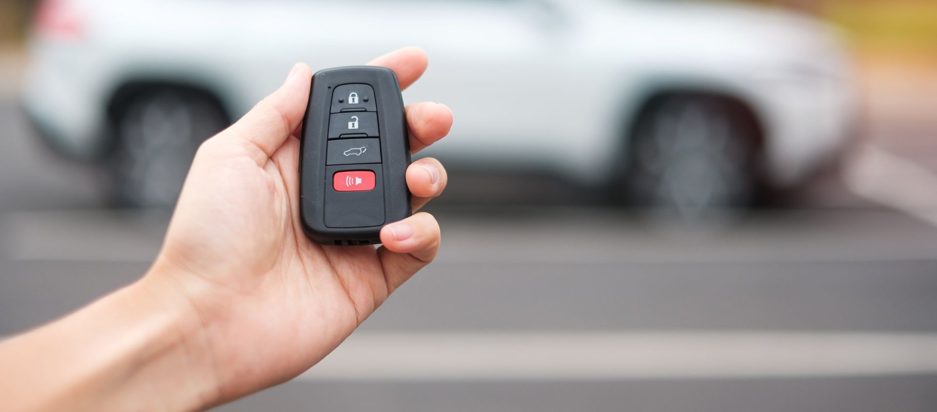 Hand holding car remote control