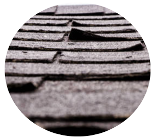 Close-up of black asphalt shingles on a roof with frost or snow Close-up of black asphalt shingles on a roof with frost or snow