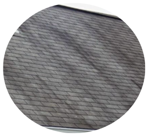 Close-up of gray shingled roof with diagonal weathered texture Close-up of gray shingled roof with diagonal weathered texture