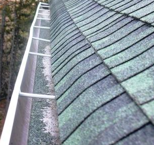 Close-up of gray shingled roof with diagonal weathered texture Close-up of gray shingled roof with diagonal weathered texture