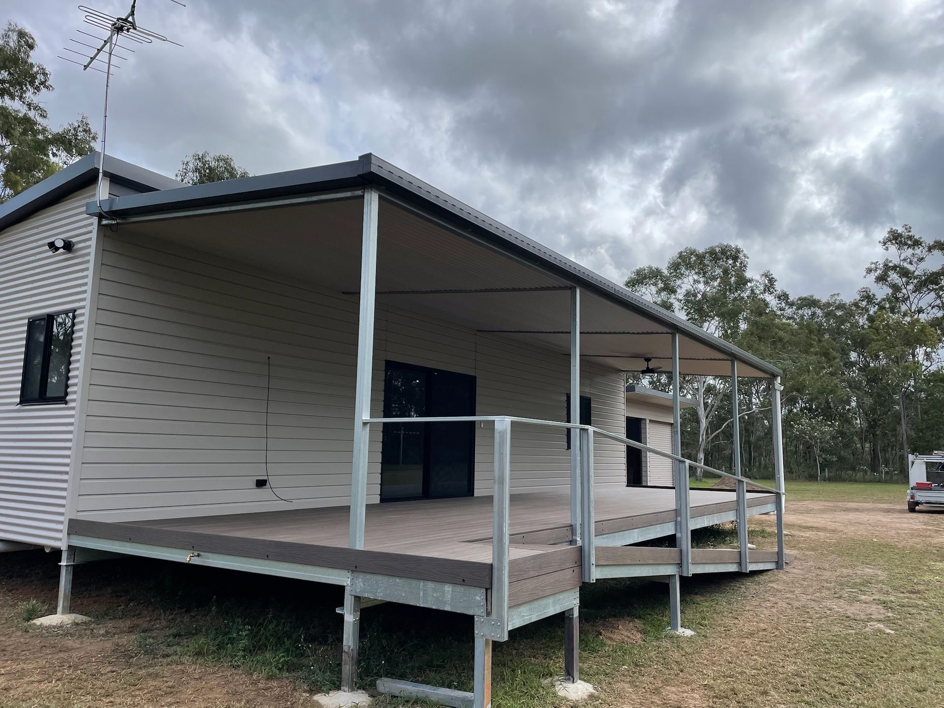 House with a deck and covered porch on a cloudy day — Steel Homes Australia in Branyan, QLD