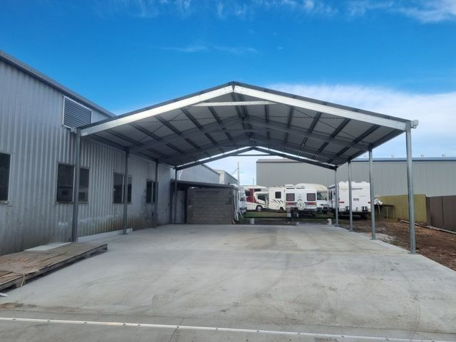 A Carport With a Roof Over a Parking Lot — Steel Homes Australia in Branyan, QLD