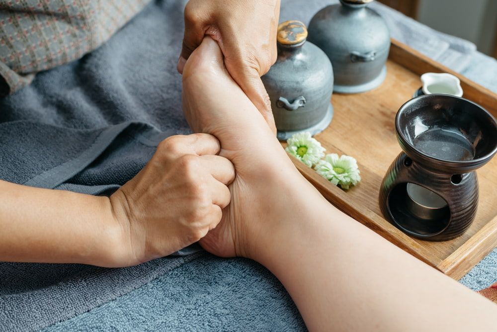 A Woman Is Getting a Foot Massage in A Spa — Burwood Back Pain in Strathfield, NSW