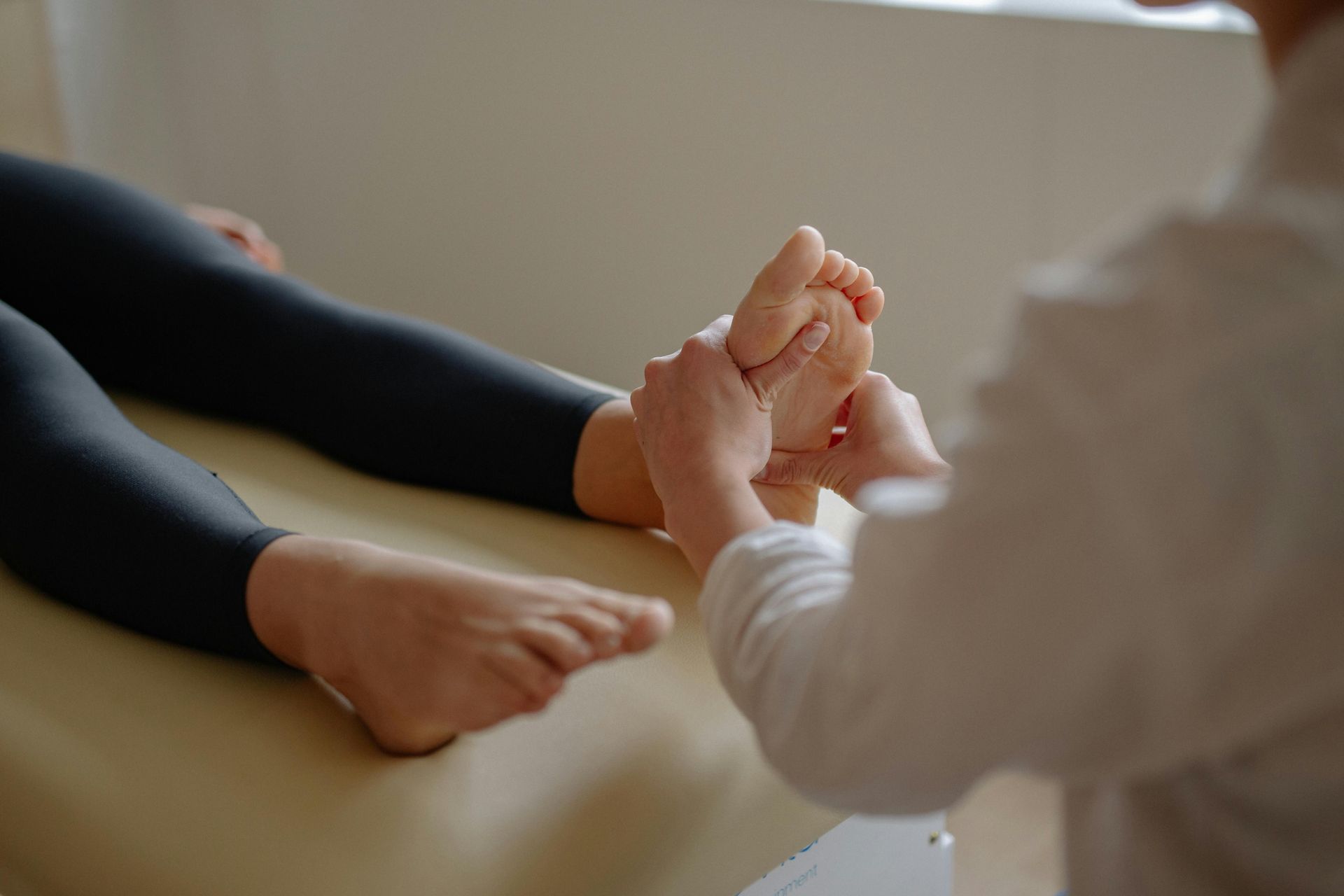 A Person Is Giving a Foot Massage to Another Person — Burwood Back Pain in Strathfield, NSW