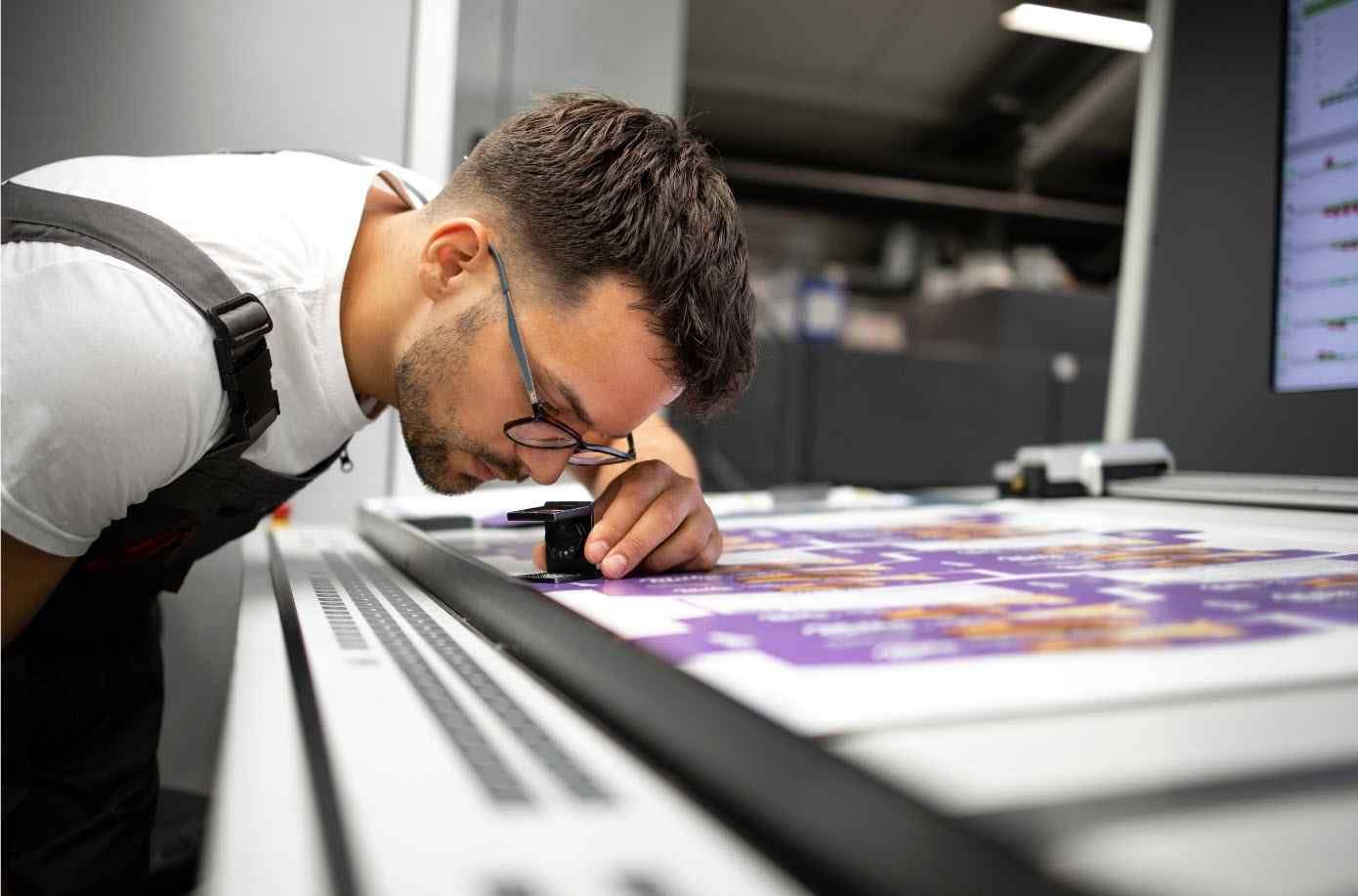 Pressman looking at a press sheet
