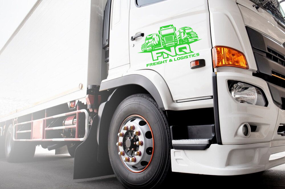 White FNC Freight & Logistics truck with logo on door and orange details.— FNQ Freight & Logistics In Portsmith, QLD