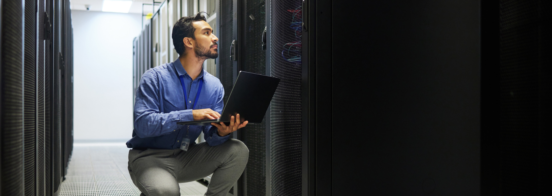 Picture of a professional in a server room. Picture of a professional in a server room.