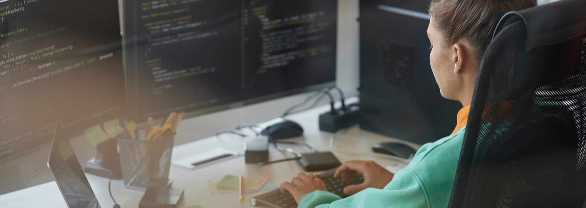 Picture of a young woman coding. 