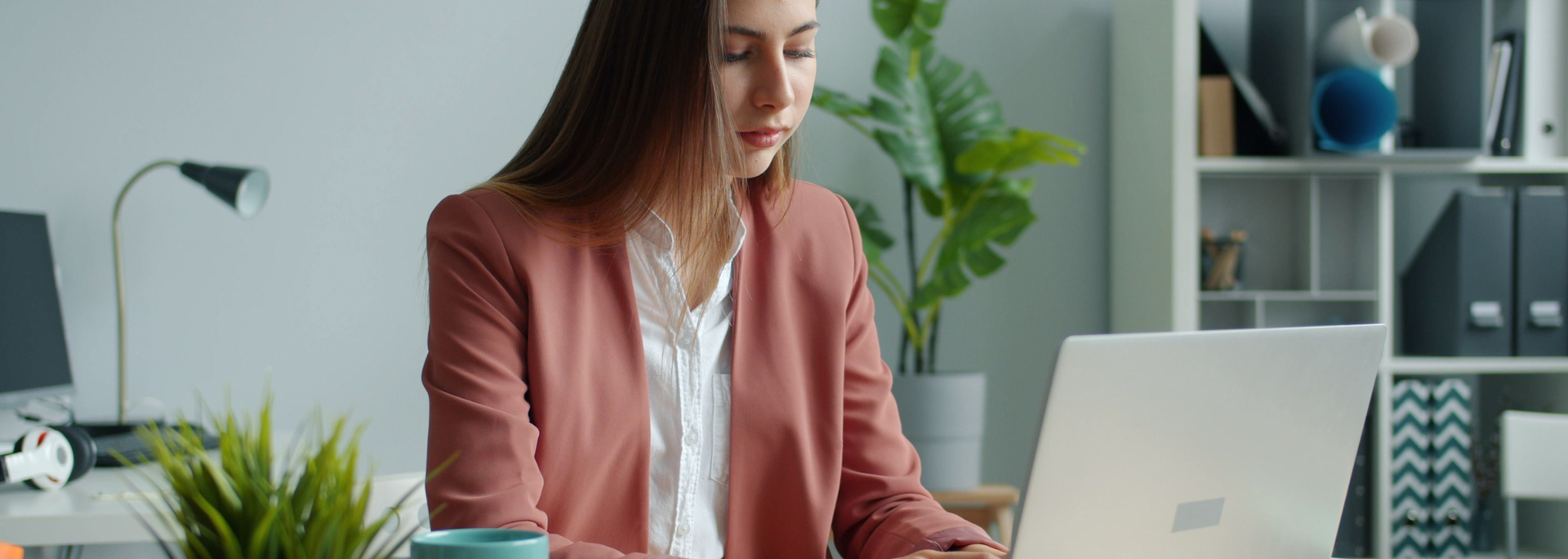 Picture of a woman sat using her laptop. 