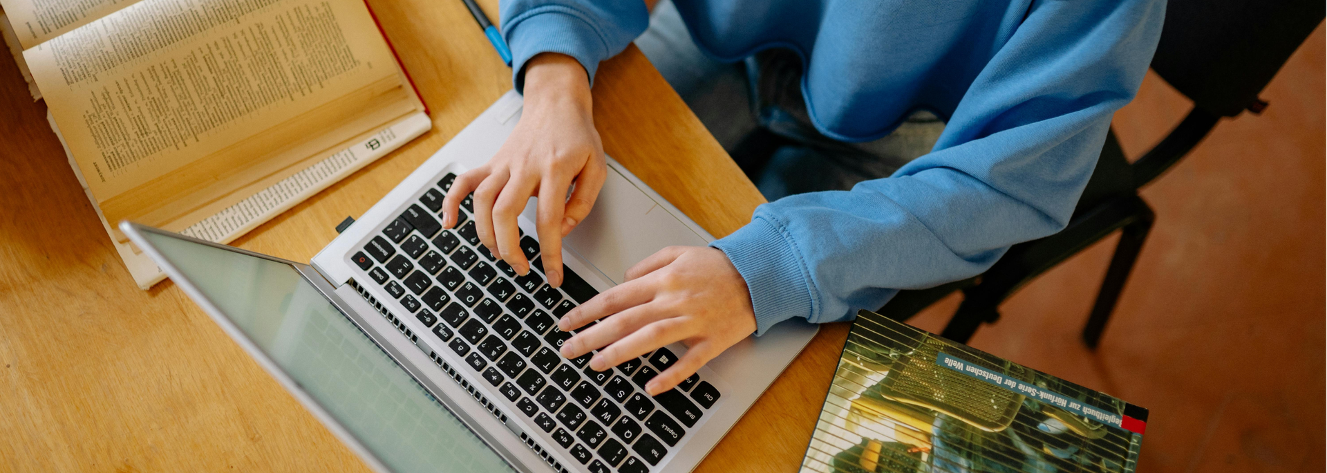 Picture of someone typing on a laptop. 