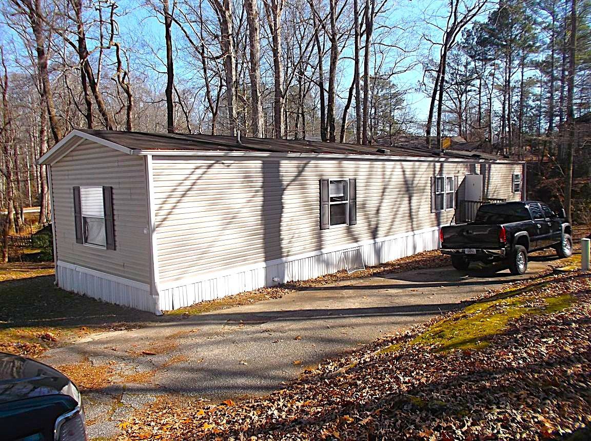 A mobile home with a truck parked in front of it.