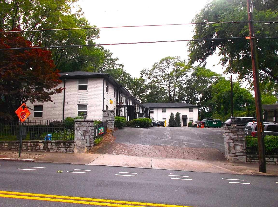A white building with a sign that says ' do not enter ' on it