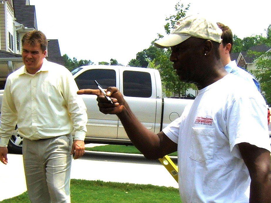 A man wearing a white shirt with the word company on it