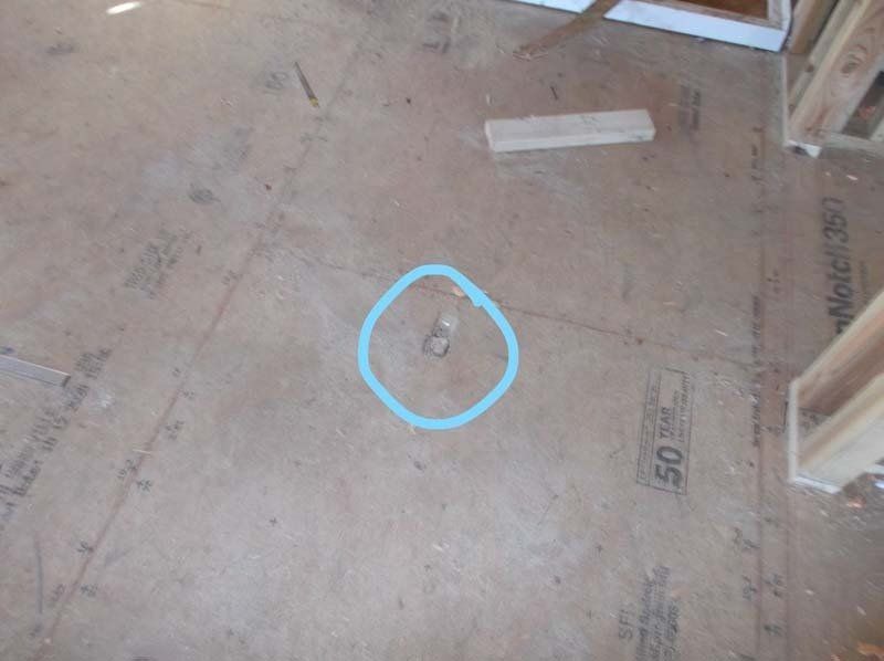 A hole in the floor with a blue circle around it