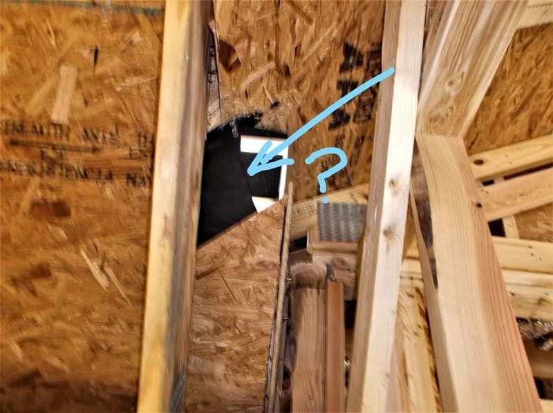A close up of a wooden structure with a question mark.