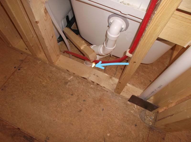 A blue arrow points to a pipe that is connected to a toilet