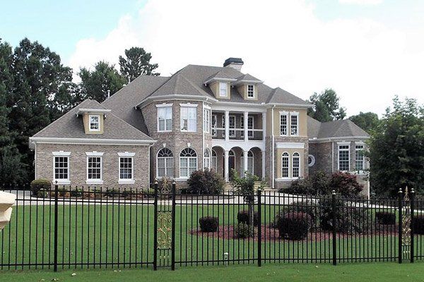 A large house with a black fence around it