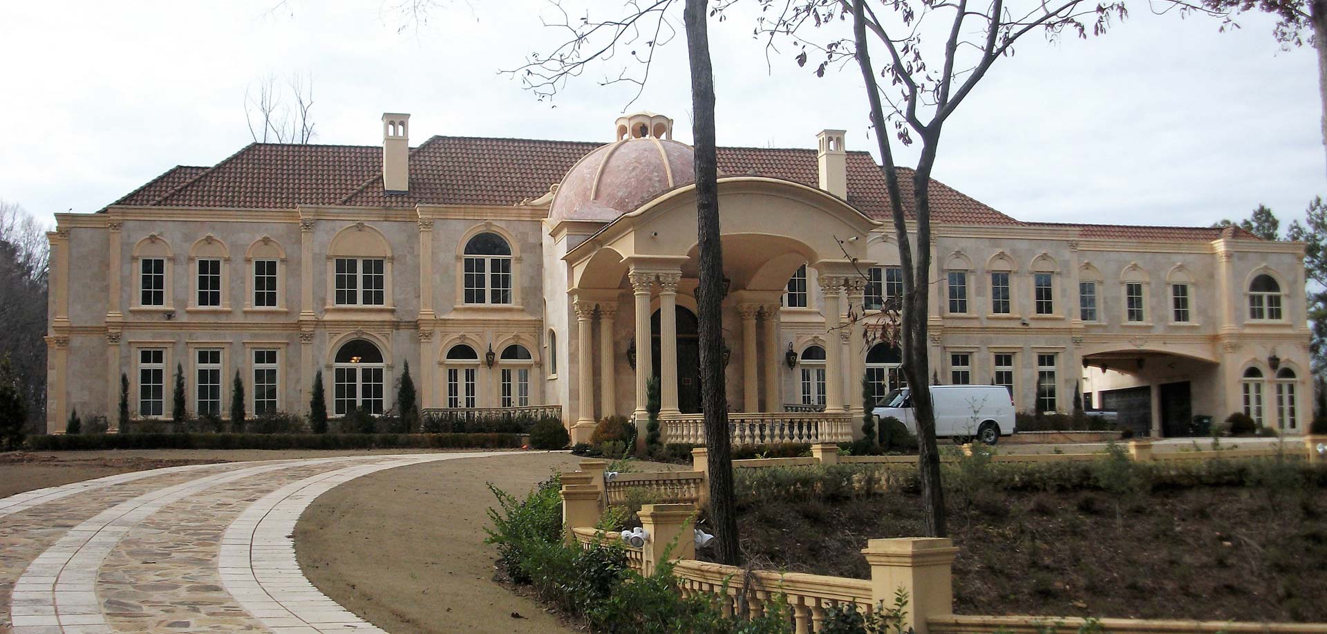 A large building with a white van parked in front of it
