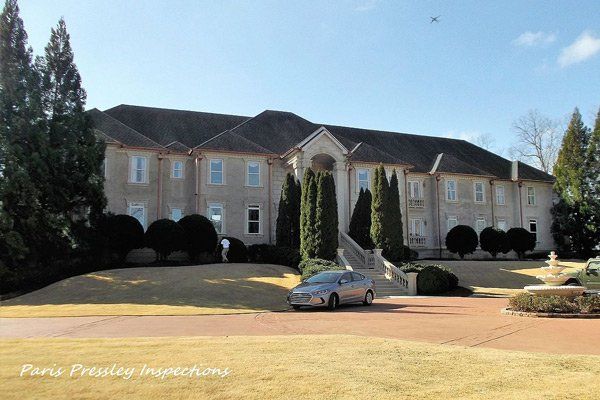 A large house with a car parked in front of it