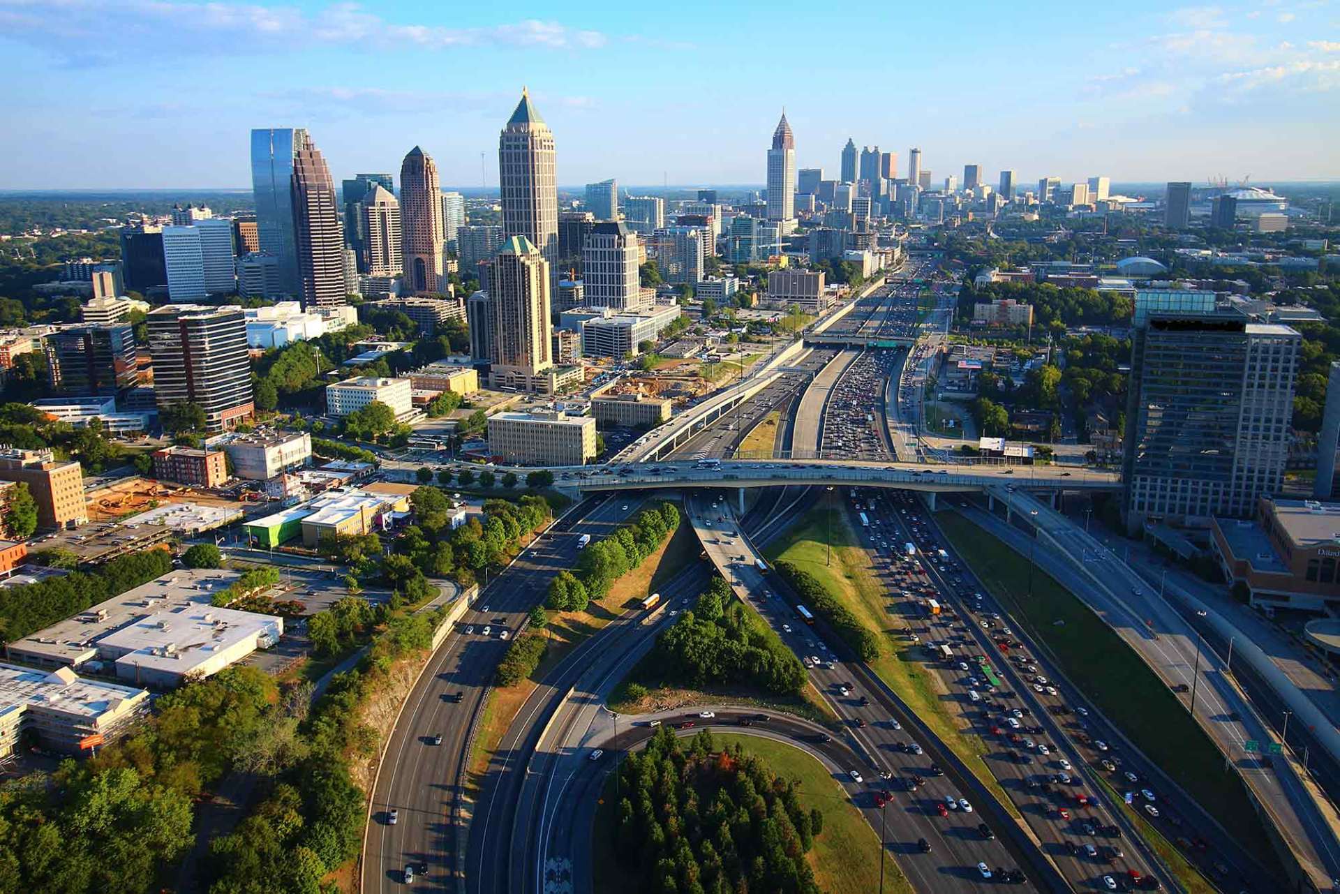 An aerial view of a city with a highway in the foreground