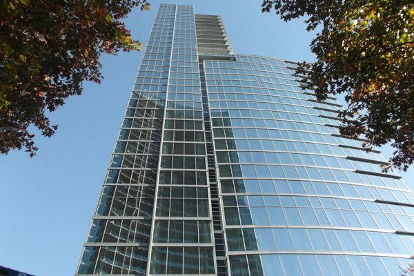 Looking up at a tall building with lots of windows