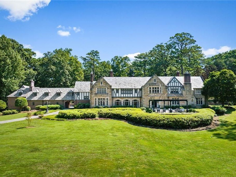 A large house with a lush green lawn in front of it
