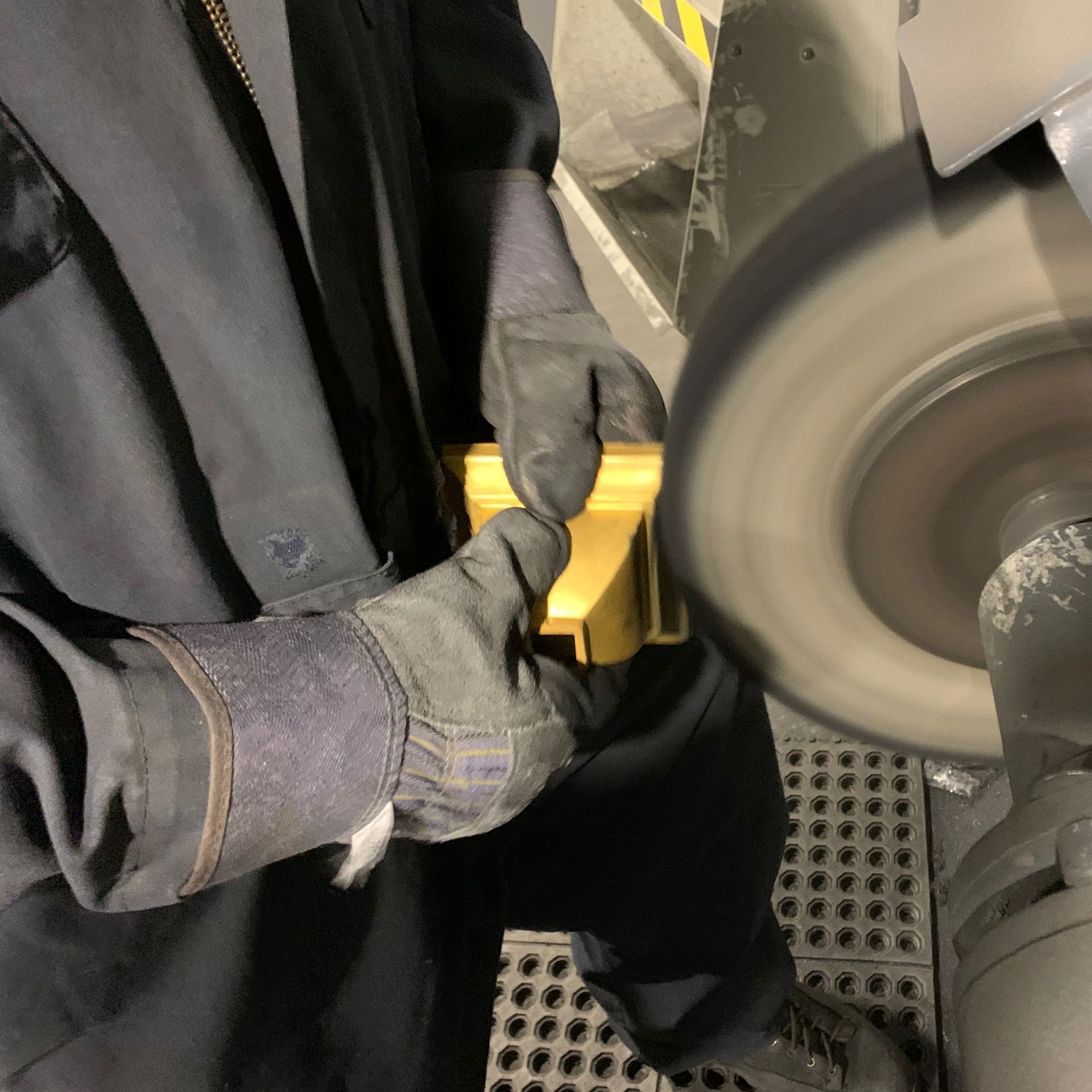 A machine is cutting a pipe in a factory.