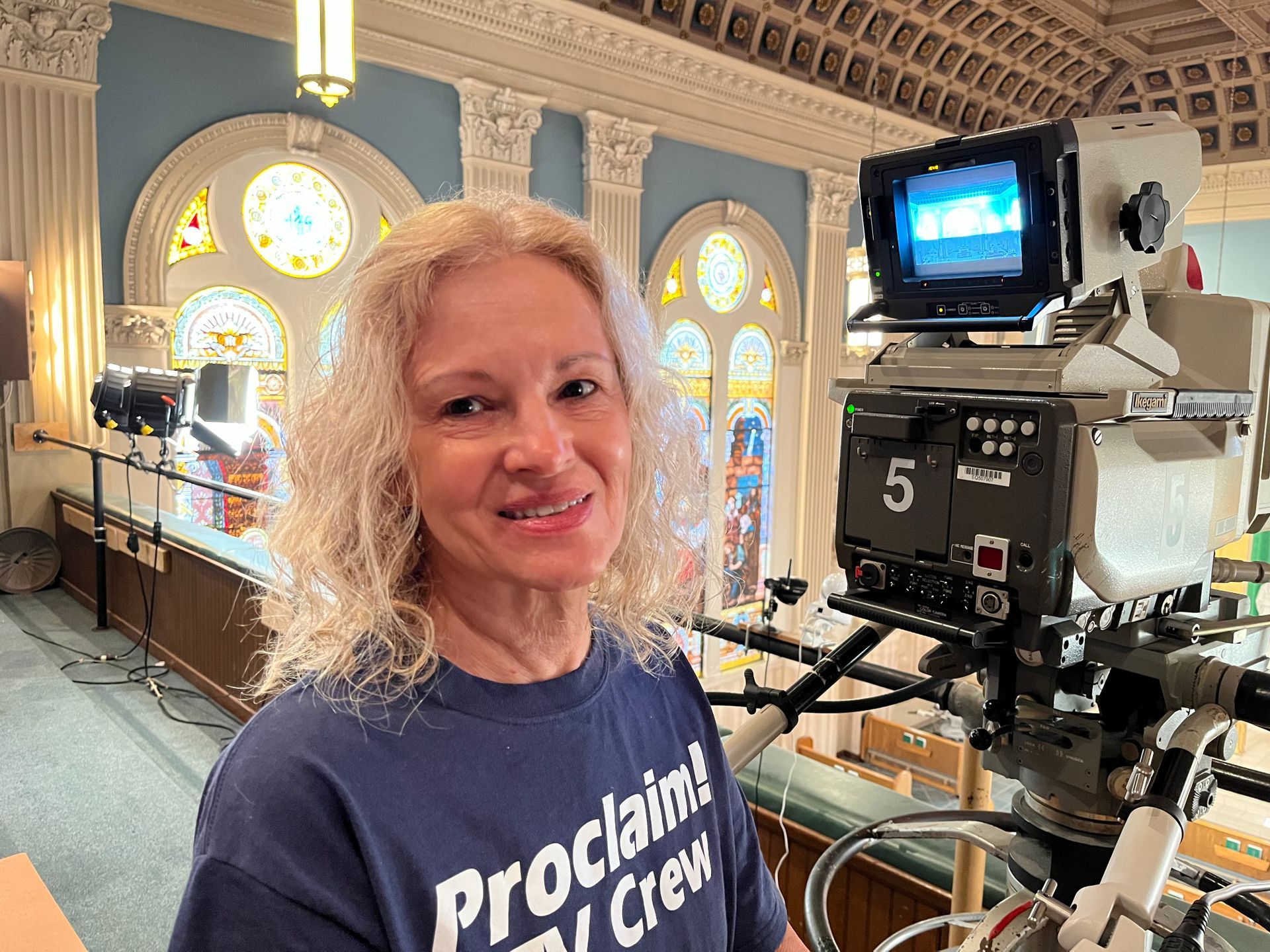 Volunteer camera operator in cathedral balcony for Proclaim TV Mass