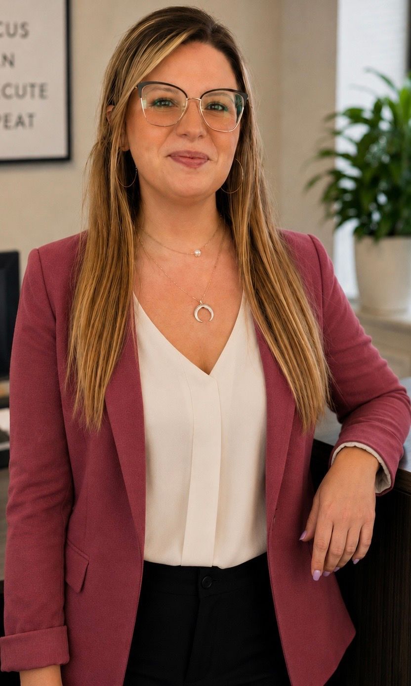 A woman wearing glasses is smiling for the camera.