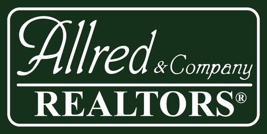 A green and white logo for alfred & company realtors