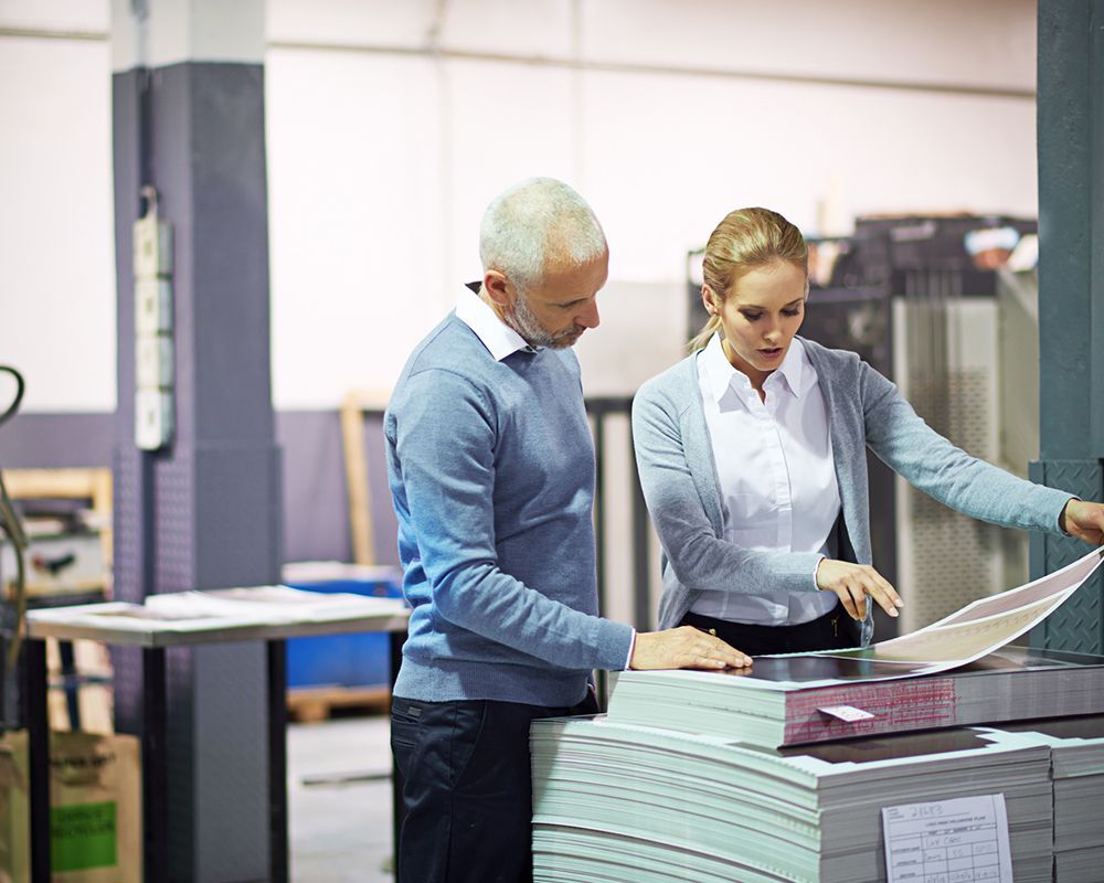Business printing at Debbie’s Copy Shop in Colleyville, TX, with two people reviewing print samples inside the shop. Business printing at Debbie’s Copy Shop in Colleyville, TX, with two people reviewing print samples inside the shop.